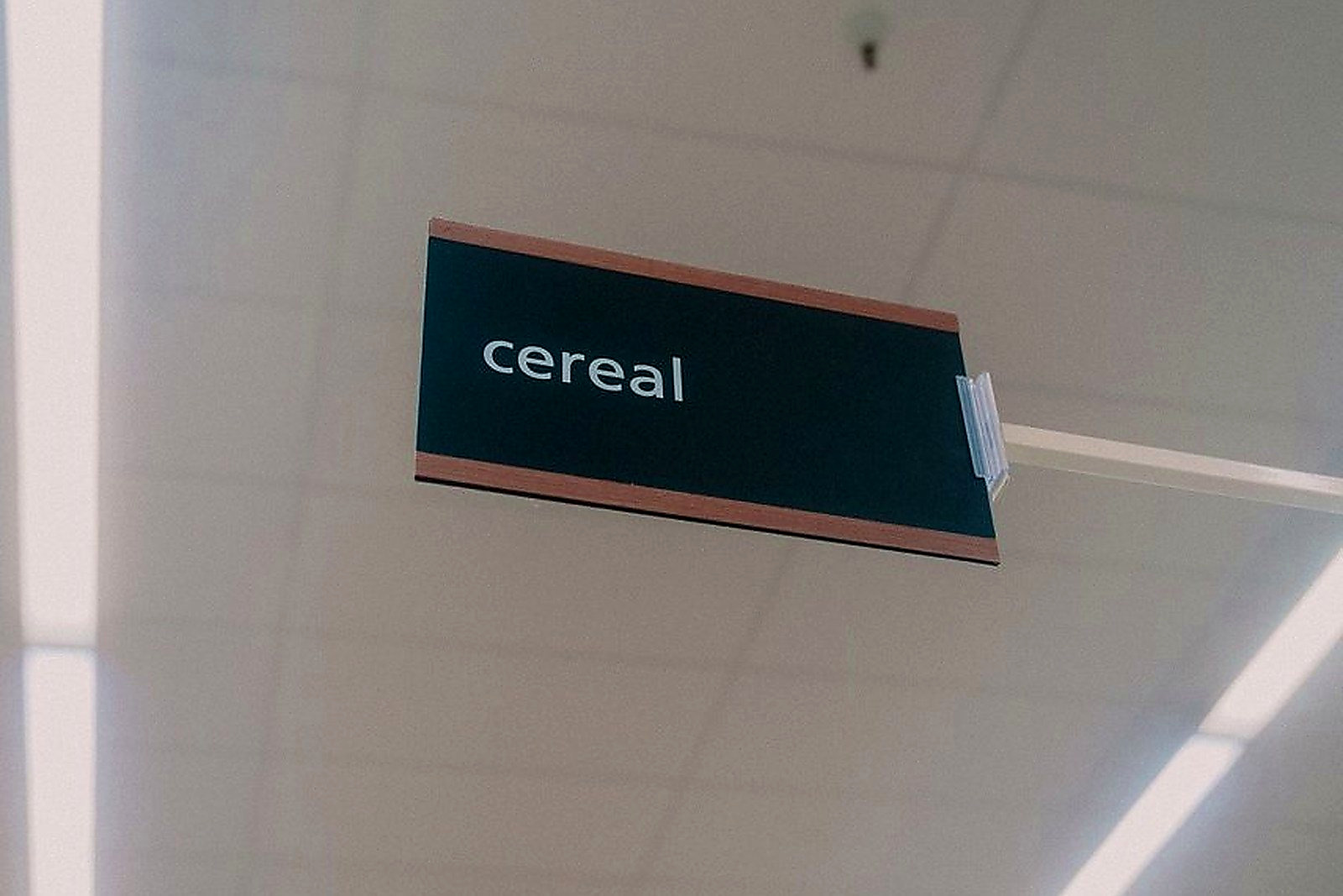 Free Low angle view of a supermarket cereal aisle, highlighting a prominent sign. Stock Photo