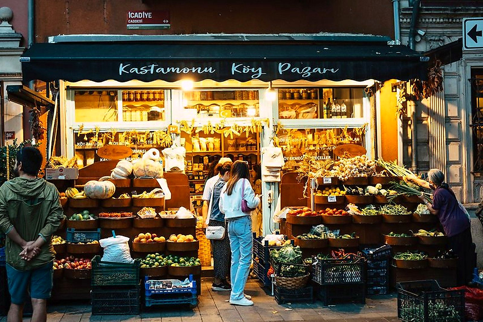 Free People shopping at Kastamonu shop at dusk, filled with fresh produce and warm lighting. Stock Photo
